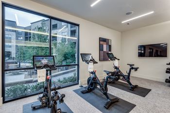 Fitness center with cardio theater, strength equipment, free weights and yoga/spin area with peloton bikes